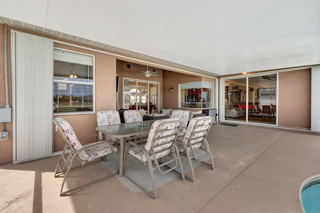 view of patio featuring ceiling fan and a swimming pool