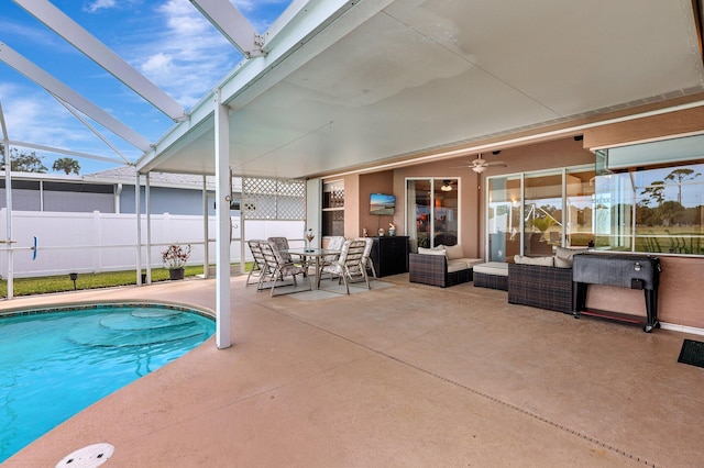 view of pool featuring a lanai, an outdoor living space, a patio, and ceiling fan