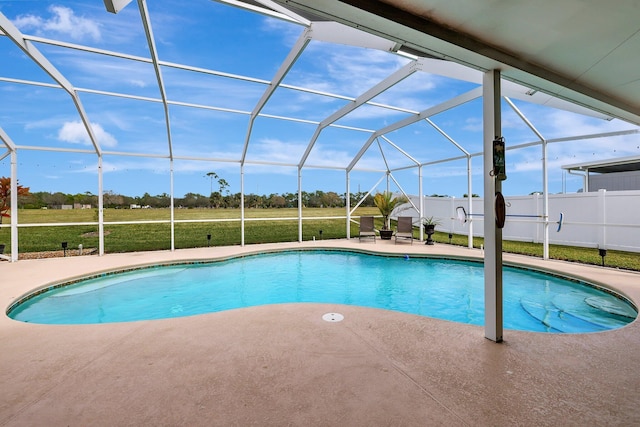 view of pool with a patio area, a lanai, and a lawn