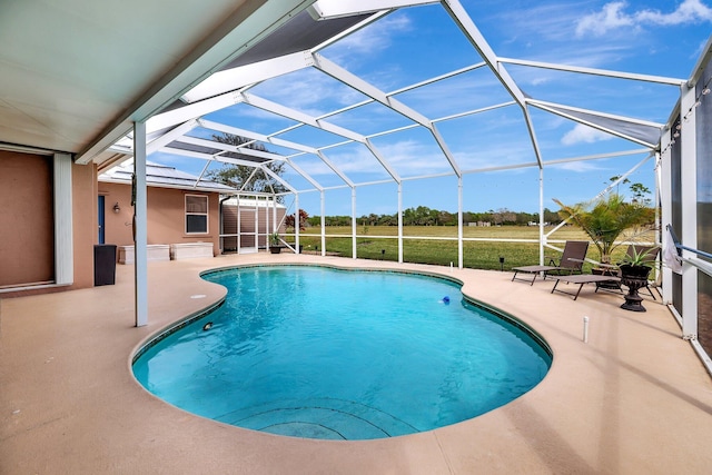 view of swimming pool featuring a lanai and a patio