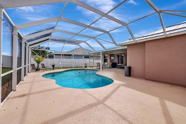 view of pool featuring a patio and glass enclosure