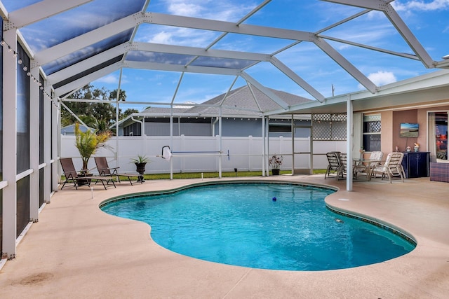 view of swimming pool featuring a lanai and a patio