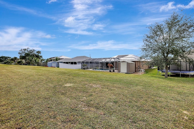 view of yard featuring a storage shed and a trampoline