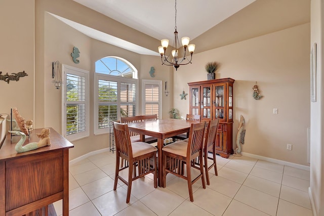 tiled dining area featuring a chandelier and vaulted ceiling