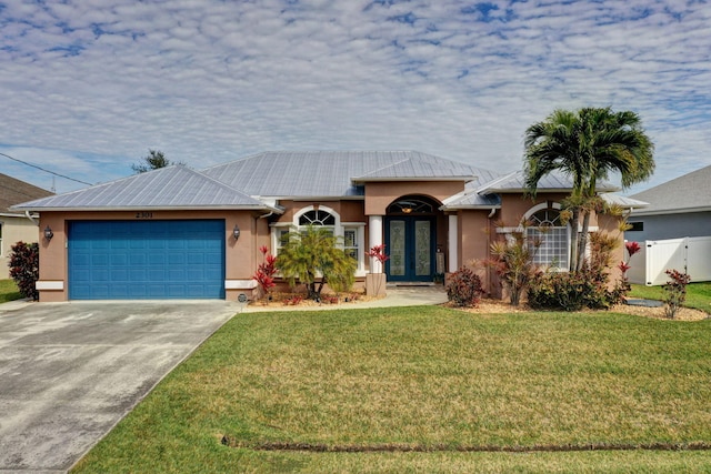 ranch-style home with a garage, a front yard, and french doors