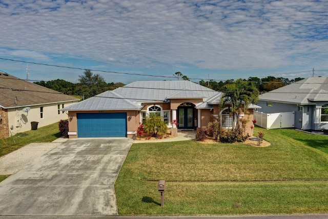 ranch-style home with a garage, a front yard, and french doors