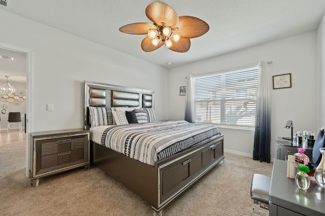 carpeted bedroom with ceiling fan with notable chandelier