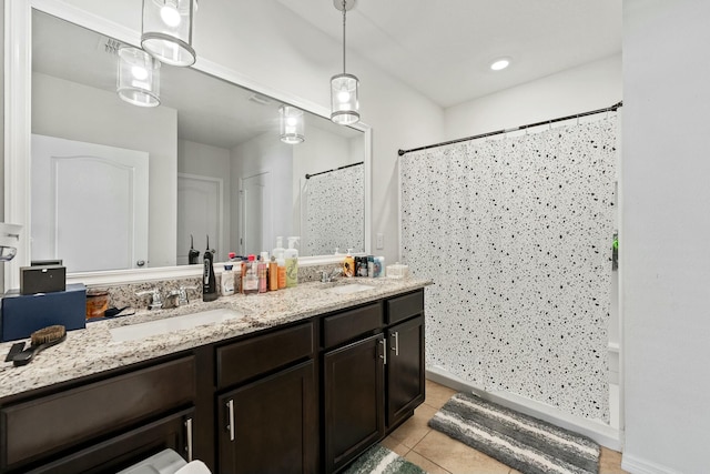 bathroom with tile patterned floors, vanity, and walk in shower