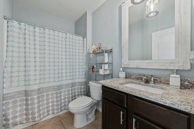 bathroom with tile patterned floors, vanity, toilet, and a textured ceiling