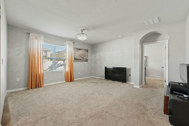 living room with light carpet and a textured ceiling