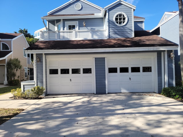 view of front of property with a garage and a balcony