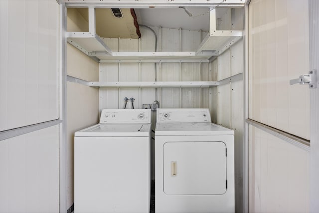 clothes washing area featuring washer and clothes dryer