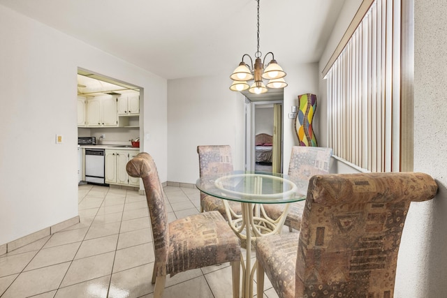 dining space featuring light tile patterned floors and an inviting chandelier