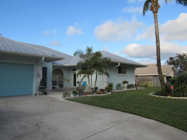 single story home featuring a front lawn and a garage