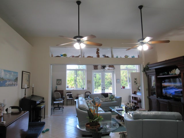 living room featuring ceiling fan, french doors, light tile patterned floors, and lofted ceiling