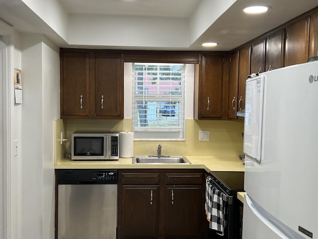 kitchen featuring dark brown cabinetry, stainless steel appliances, and sink