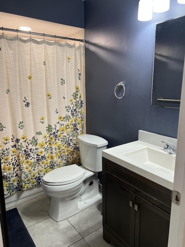 bathroom with tile patterned flooring, vanity, and toilet