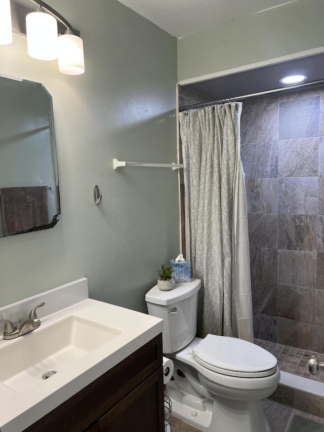 bathroom with vanity, toilet, and walk in shower