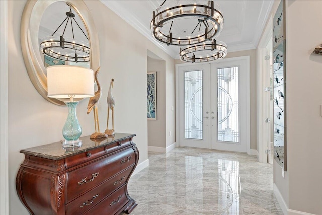 foyer with french doors, a chandelier, and ornamental molding