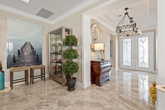 entryway featuring an inviting chandelier, ornamental molding, and french doors