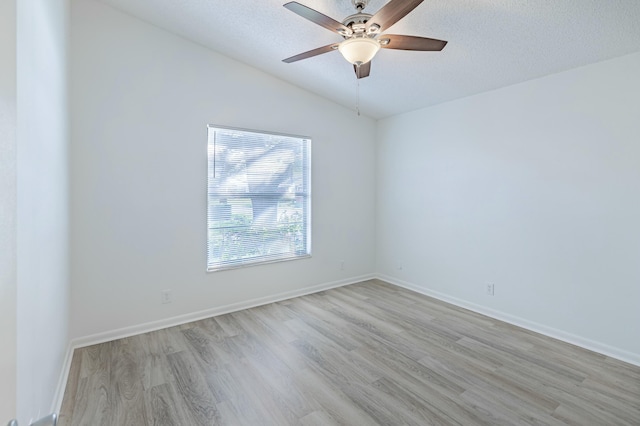 unfurnished room with vaulted ceiling, ceiling fan, a textured ceiling, and light wood-type flooring