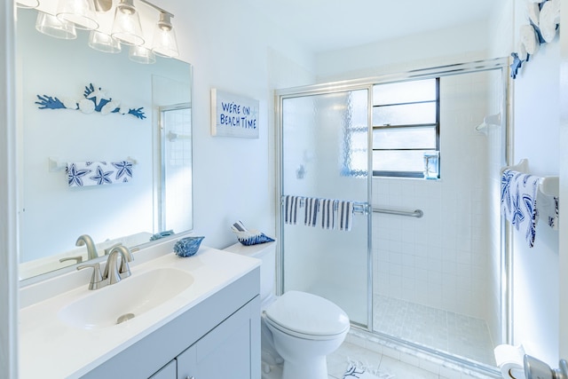 bathroom with vanity, walk in shower, tile patterned floors, and toilet