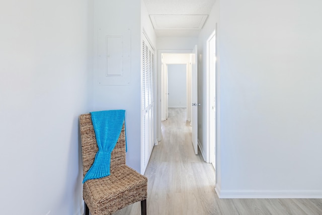 corridor featuring electric panel and light wood-type flooring