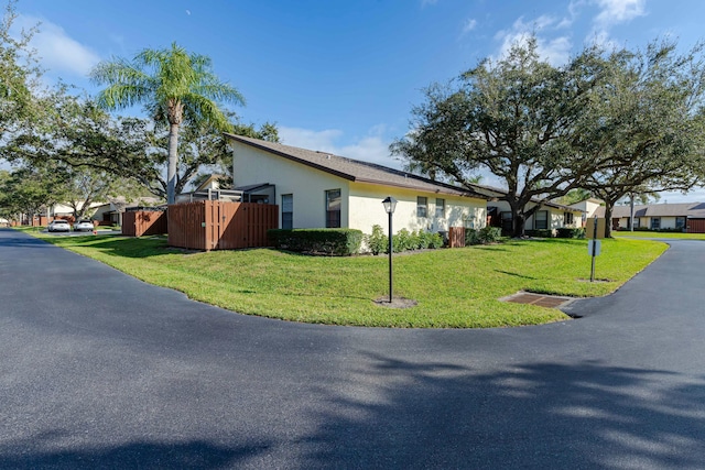 view of property exterior with a lawn