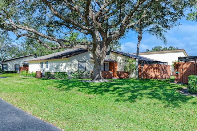 ranch-style house with a front lawn