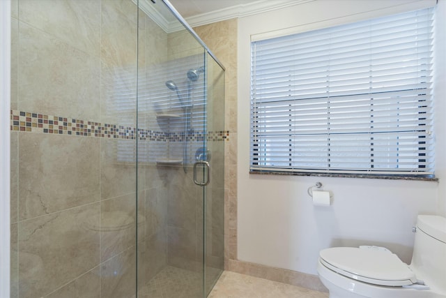 bathroom featuring toilet, tile patterned floors, a shower with door, and ornamental molding