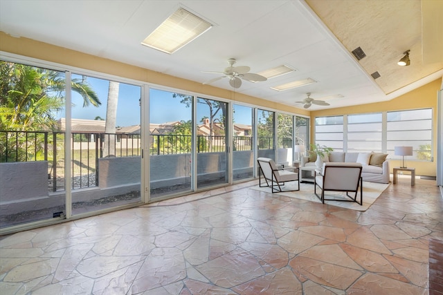 unfurnished sunroom with ceiling fan