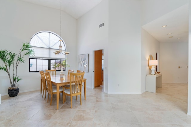 dining area with high vaulted ceiling