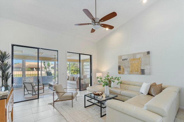 living room with ceiling fan, light tile patterned floors, and high vaulted ceiling