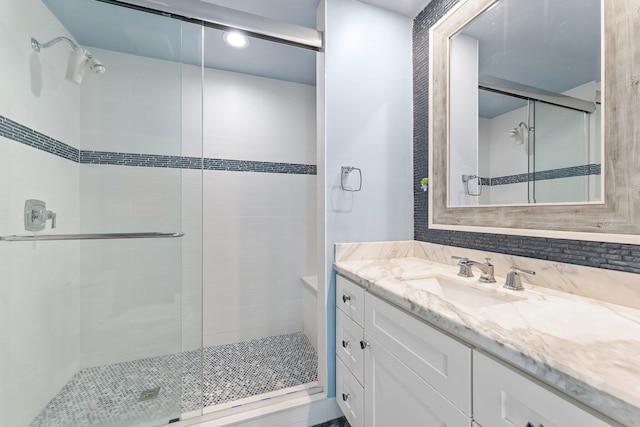 bathroom featuring an enclosed shower and vanity