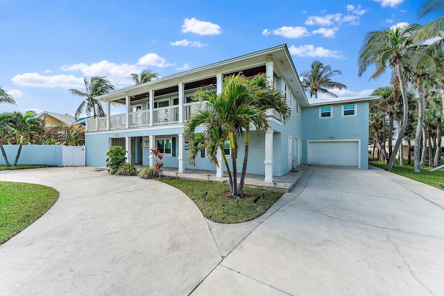 view of front of home featuring a balcony and a garage