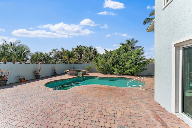 view of swimming pool with a patio area and an in ground hot tub