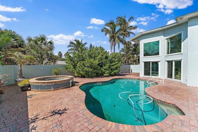 view of swimming pool featuring cooling unit, an in ground hot tub, and a patio