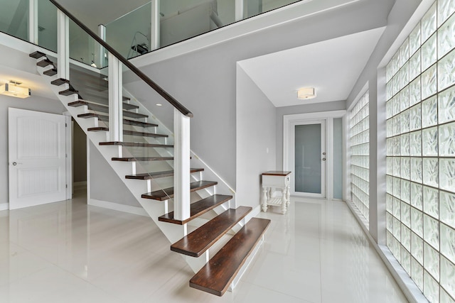 staircase featuring tile patterned flooring