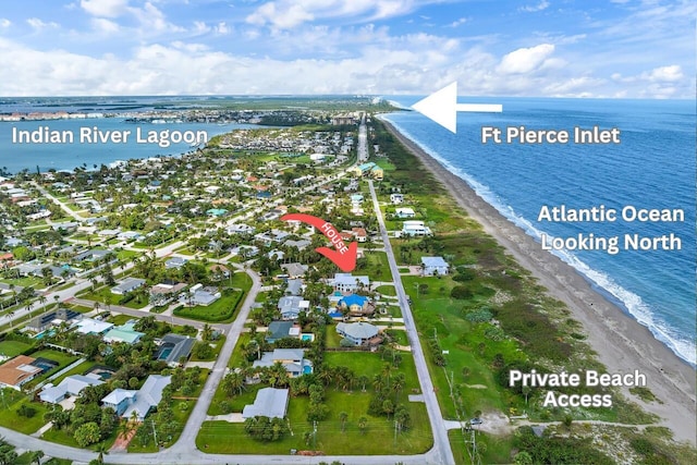 aerial view featuring a water view and a view of the beach