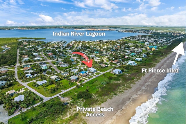 bird's eye view featuring a water view and a view of the beach