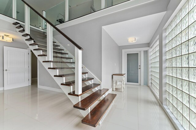 foyer entrance featuring light tile patterned floors and billiards