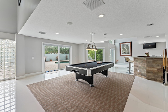 playroom featuring bar, a textured ceiling, and billiards