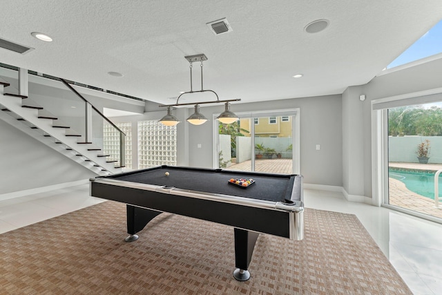 playroom featuring a textured ceiling, billiards, and light tile patterned floors