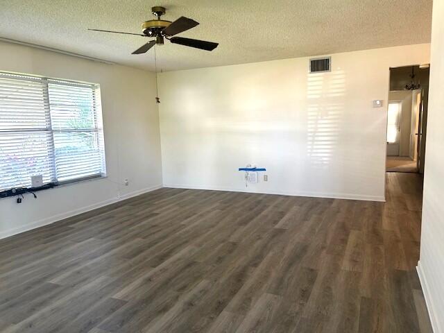 unfurnished room featuring dark hardwood / wood-style floors and a textured ceiling