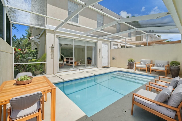 view of swimming pool featuring glass enclosure and a patio