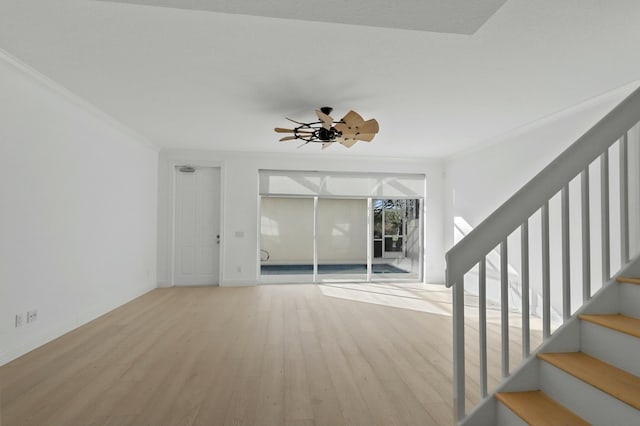 unfurnished living room featuring light wood-type flooring, ceiling fan, and crown molding