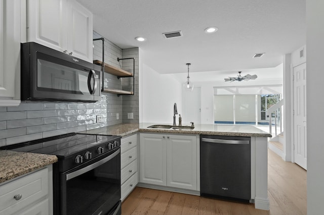 kitchen with dishwasher, electric range oven, white cabinets, and sink