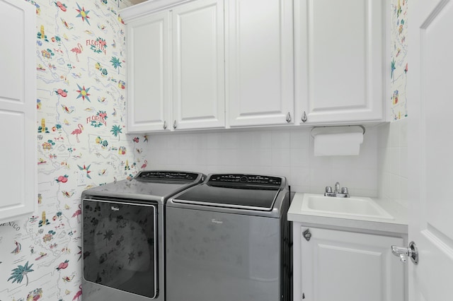 laundry room featuring sink, cabinets, and independent washer and dryer