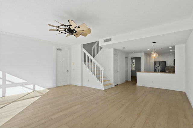 unfurnished living room with light hardwood / wood-style floors