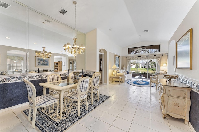 dining space featuring ceiling fan with notable chandelier, arched walkways, visible vents, and tile patterned floors